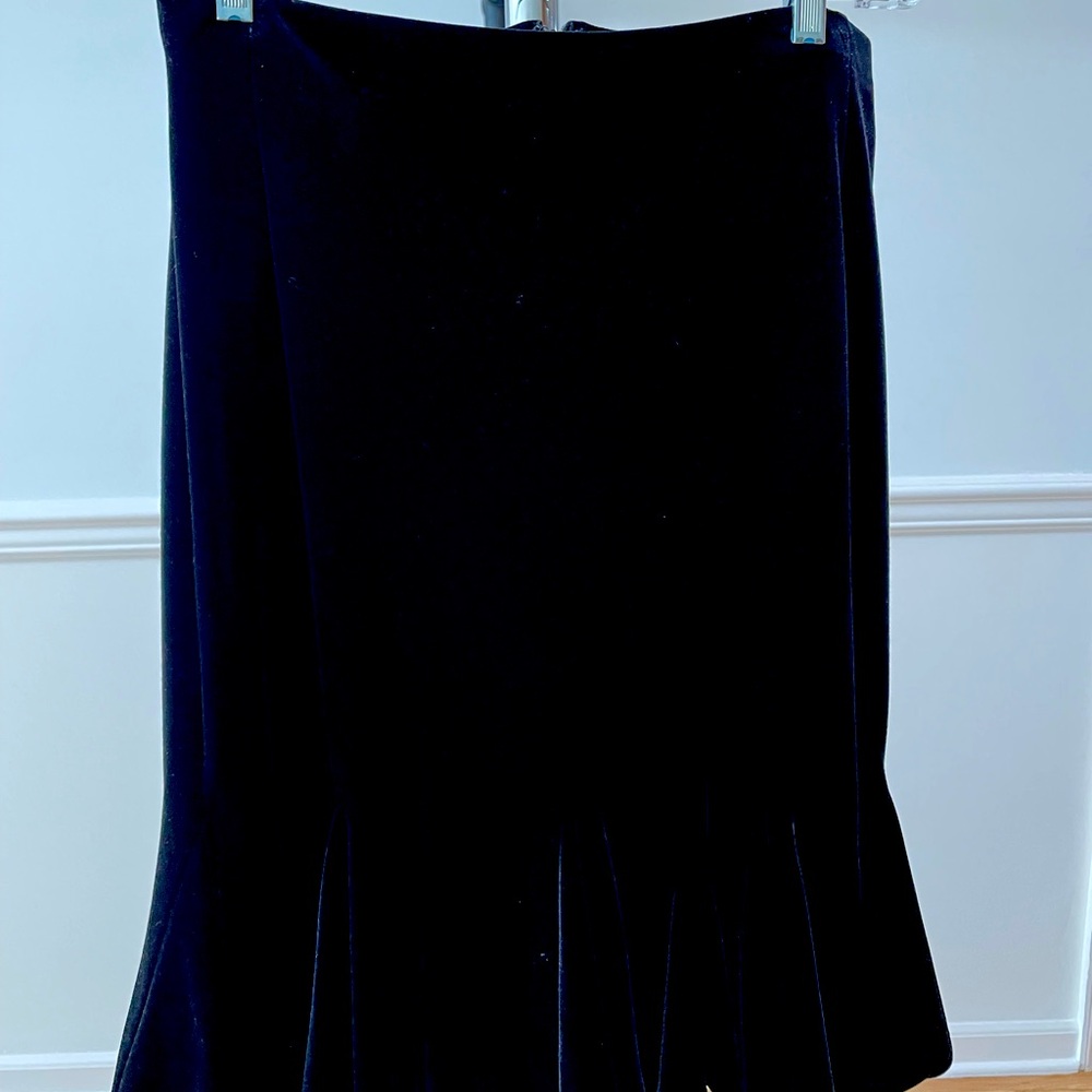 size 10 black velvet skirt with back zip and soft ruffle hem. below the knee